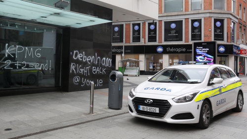 A garda car beside graffiti on Debenhams' Henry Street, Dublin, last month (RollingNews.ie)