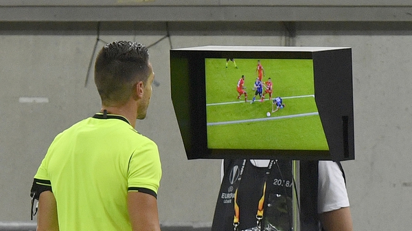 Referee Carlos Del Cerro Grande reviews the VAR monitor during a Europa League fixture in August