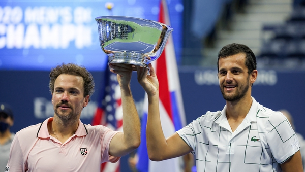 Mate Pavic (R) of Croatia and Bruno Soares (L) of Brazil celebrate with the trophy