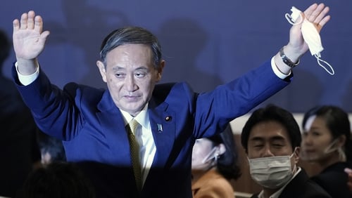 Yoshihide Suga acknowledges the crowd as he is elected new head of Japan's ruling party the LDP