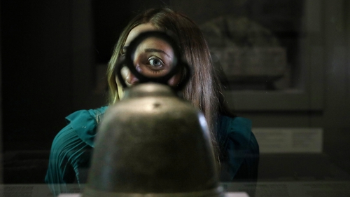 Deirdre Geraghty looking at an 8th/9th century hand bell, which was found near Glendalough
