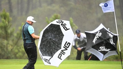 Daniel Young of Scotland wrestles with his umbrella in Obidos