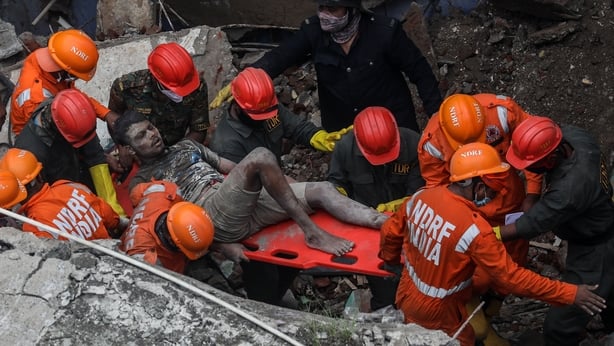 13 dead, 25 feared trapped in India building collapse