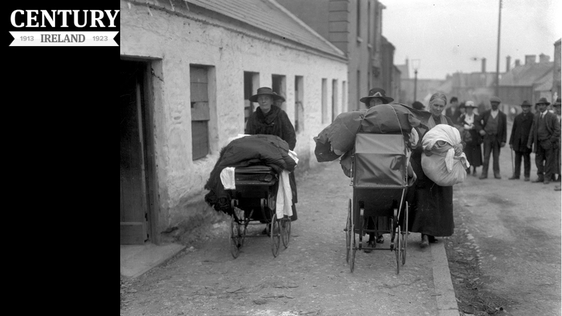 Three local women pushing prams, laden with clothes and blankets, leave Balbriggan, County Dublin, in the wake of the sack of that village after an attack by the Black and Tans on 20 September 1920.
Photo: RTÉ Archives 0505/081