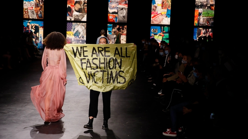 Why did a protester storm Paris Fashion Week?