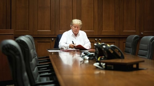 A handout image from the White House shows Donald Trump at work while being treated for Covid-19