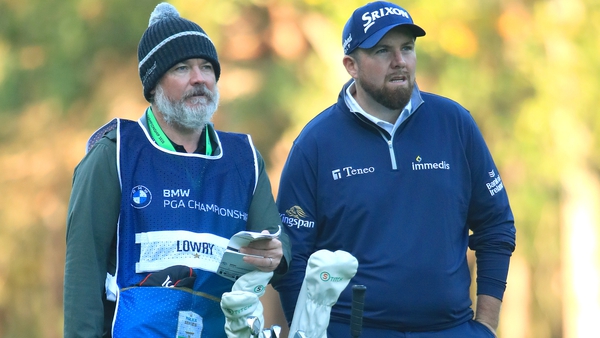 Lowry and his caddy Brian 'Bo' Martin (L) during his second round at Wentworth
