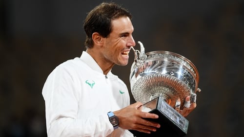 Rafael Nadal taking a bite of the Coupe des Mousquetaires has become an iconic image in sport