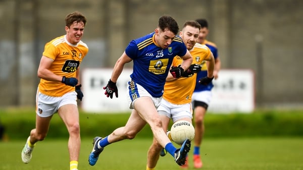 Conor Byrne of Wicklow in action against Eoin Nagle, left, and Kevin Quinn of Antrim
