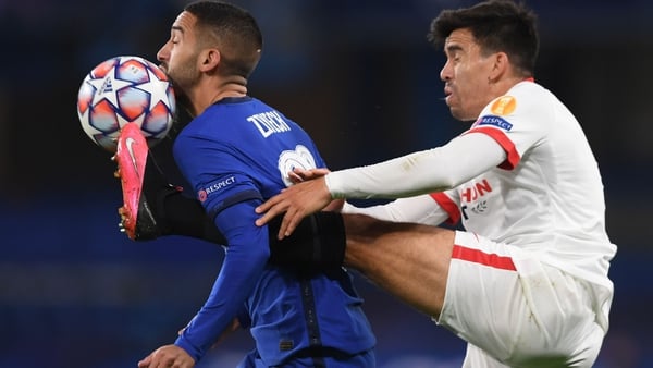 Sevilla's Marcos Acuna tackles Chelsea midfielder Hakim Ziyech