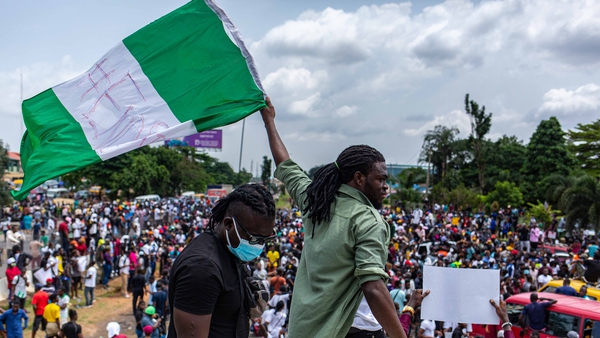A Nigerian youth waves the Nigerian national flag in protest against the Special Anti-Robbery Squad (SARS) in Lagos last October.