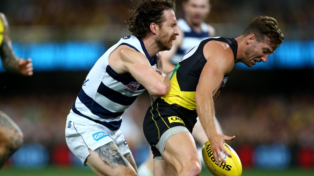 The Cats' Zach Tuohy keeps close tabs on Kane Lambert of the Tigers
