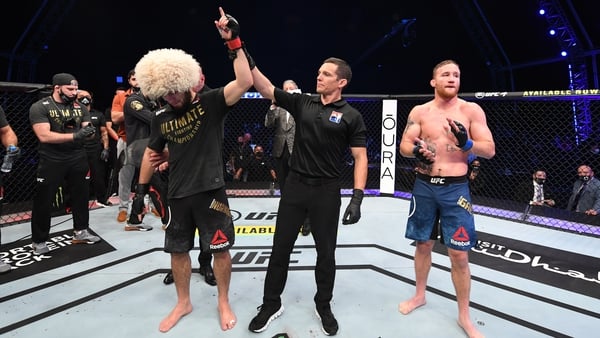 Khabib Nurmagomedov has his arm raised in victory, possibly for the final time, as he calls time on his UFC career