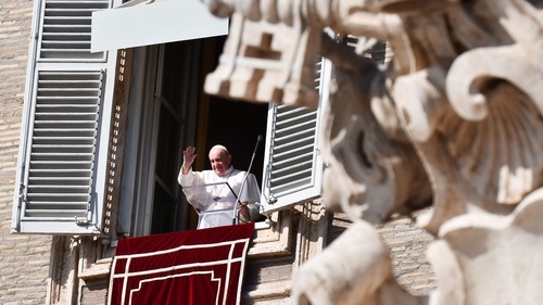 Pope Francis waves to pilgrims gathered in St Peter's Square during his Sunday Angelus prayer