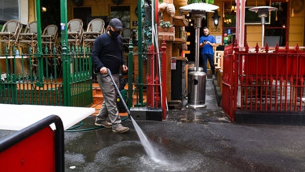 A man cleans as restaurants and cafes prepare for opening in Melbourne