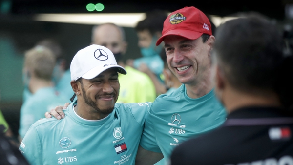 Hamilton (L) poses with Toto Wolff as they celebrate their record seventh consecutive constructor's championship