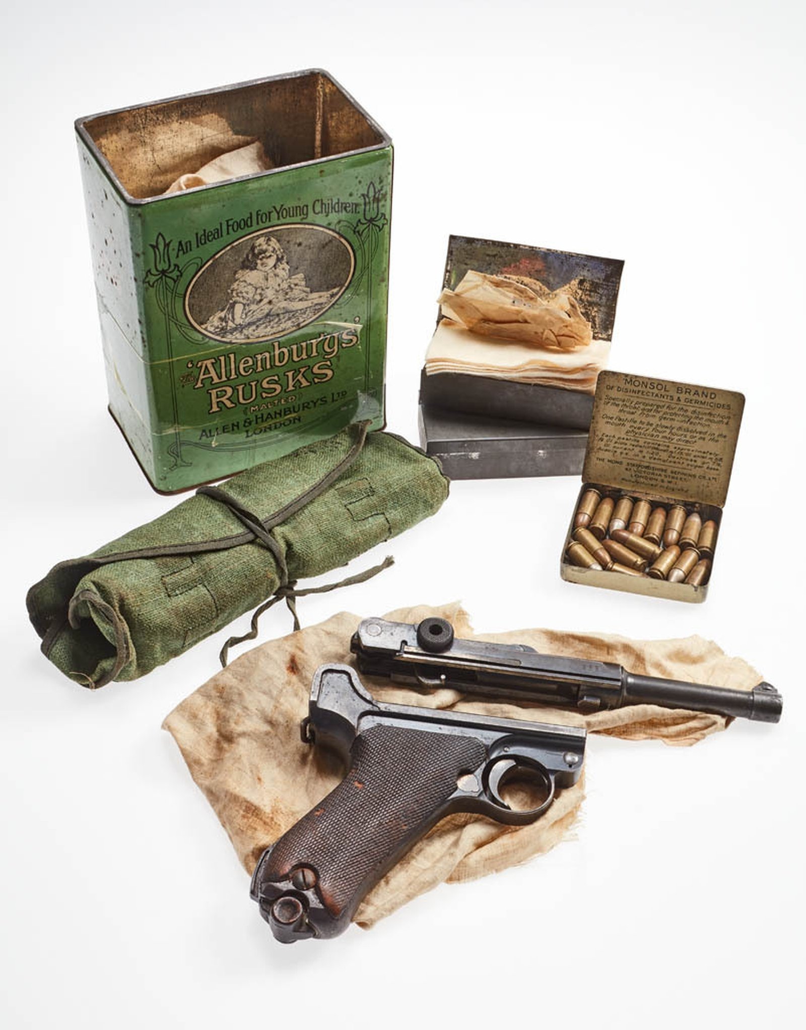 Image - Luger pistol, ammunition and cleaning kit found stashed in a Allensbury's Rusk tin, c. 1922. Image courtesy of the National Museum of Ireland HA:2012.25