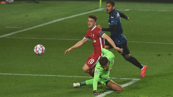 Diogo Jota lifts the ball past Atlanta keeper Marco Sportiello for his and Liverpool's first goal