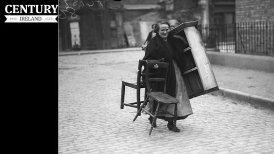 A woman fleeing her home with some of her furniture after the sack of Balbriggan
Photo: RTÉ Archives