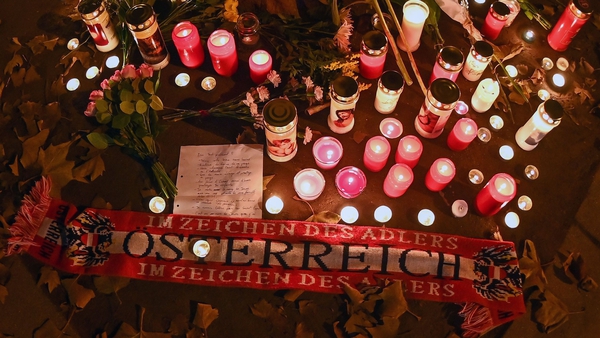 Flowers, candles and an Austria scarf are left at a memorial site at the scene of an attack in Vienna