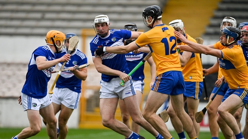 Ryan Mullaney of Laois is tackled by Cathal Malone of Clare