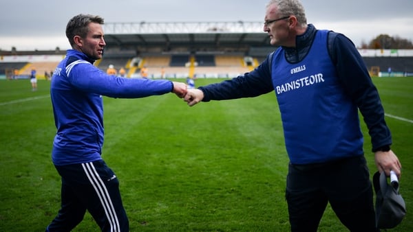 Laois manager Eddie Brennan, (L) fist bumps Clare manager Brian Lohan after the game
