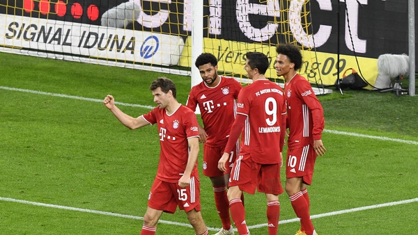 Bayern's Leroy Sane, right, celebrates with teammates after scoring his side's third goal