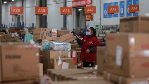 A Chinese warehouse worker checks the delivery information for packages on Singles' Day