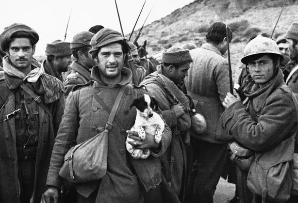 A group of Republican soldiers talk to journalists during the Spanish Civil War, including the American novelist Ernest Hemingway (seen with his back to the camera). O'Donnell was in Spain when the war broke out (Photo by © Hulton-Deutsch Collection/CORBIS/Corbis via Getty Images)
