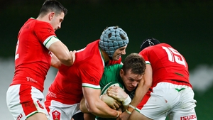 Chris Farrell of Ireland is tackled by Owen Watkin (L), Jonathan Davies and Leigh Halfpenny (R).