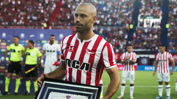 Mascherano poses with a plaque given to him by San Lorenzo soccer club to honor his career in January