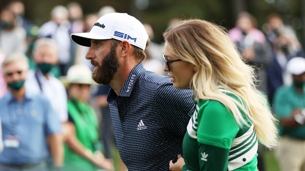 Dustin Johnson walks with fiancée Paulina Gretzky after winning the Masters
