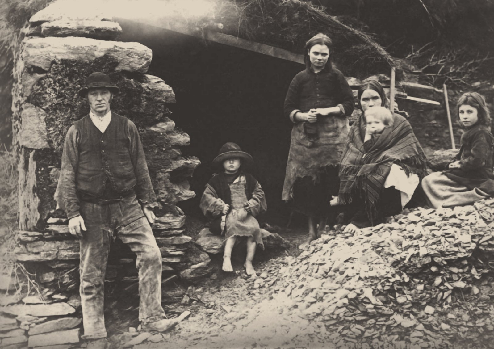 Image - A family at the ruins of their house in Killarney, 1888 in a private collection. (Photo: Fine Art Images/Heritage Images/Getty Images)