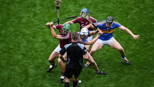 David Burke (L) and Johnny Coen of Galway contest the throw in against Brendan Maher (L) and Dan McCormack of Tipperary in 2017