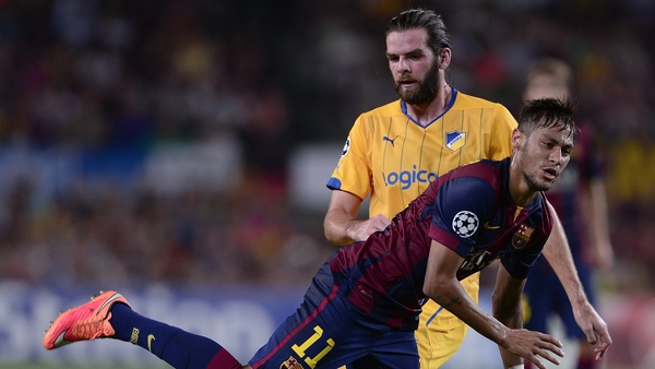 Neymar (L) falls in front of Cillian Sheridan during APOEL's September 2014 game against Barcelona
