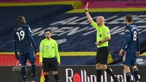 Nicolas Pepe (L) is shown a red card by atch Referee Anthony Taylor