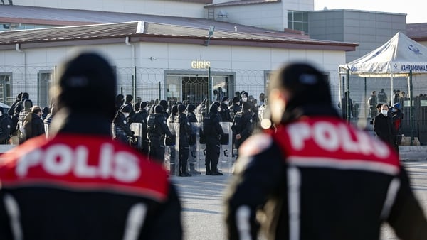 Turkish police officers stand guard outside a Turkish court in Ankara