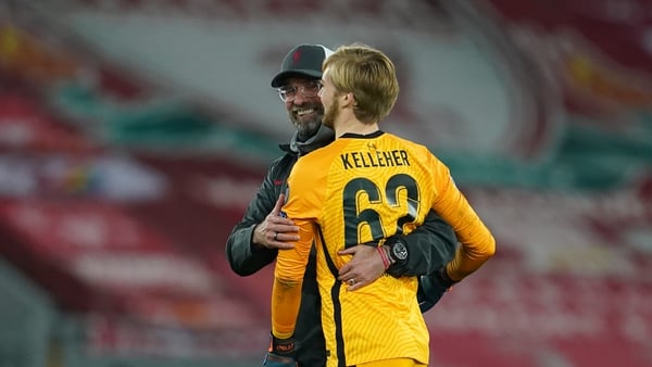 Jurgen Klopp (L) embraces Caoimhin Kelleher at the final whistle against Ajax