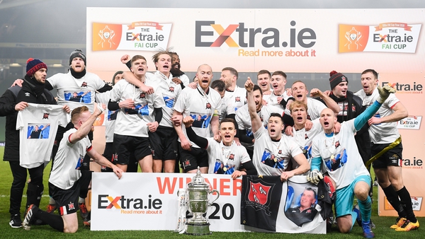 Dundalk players, wearing T-shorts in tribute to their late groundsman Harry Taaffe, start the celebrations