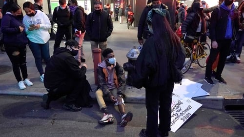 A protester has his leg bandaged after a car struck multiple Black Lives Matter protesters