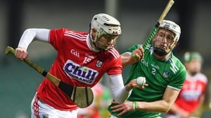 Shane Barrett of Cork tries to evade Limerick's Jimmy Quilty at the Gaelic Grounds.