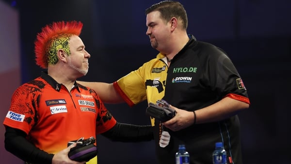 Peter Wright congratulates surprise winner Gabriel Clemens at the Ally Pally
