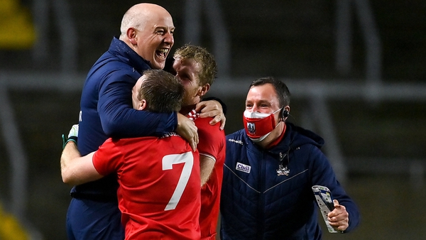 Cork manager Ronan McCarthy (L) celebrates Cork's defeat with Mattie Taylor and Ruairi Deane at the final whistle.