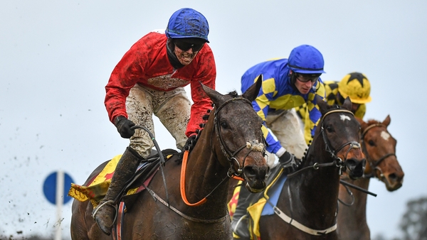 Jockey Darragh O'Keeffe, left, celebrates as he passes the finishing post after riding A Plus Tard to victory in the Savills Steeplechase