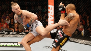 McGregor lands a kick on Poirier at UFC 178 in 2014