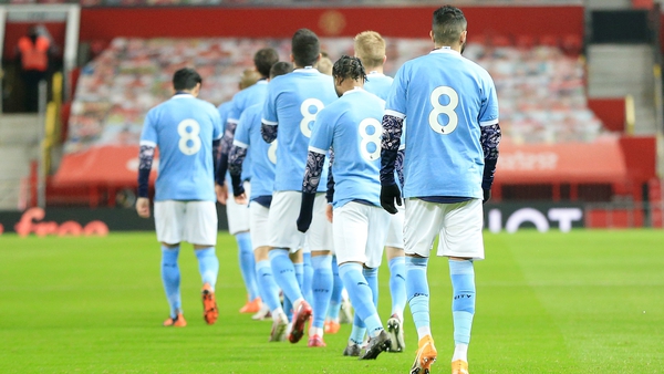 Manchester City players walk out at Old Trafford in tribute No 8 shirts in honor of Colin Bell