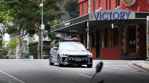 A police car patrols a local street in Brisbane, Australia