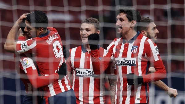 Saul Niguez celebrates with Luis Suarez and Kieran Trippier after scoring Atletico's first goal