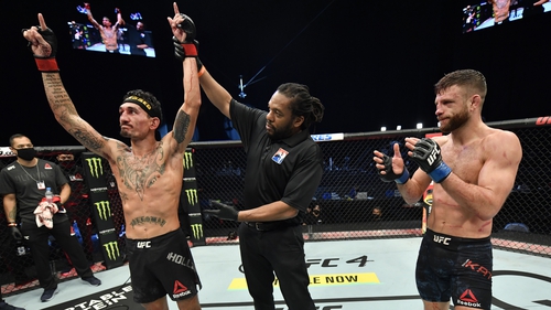 Max Holloway (L) celebrates after his unanimous-decision victory over Calvin Kattar