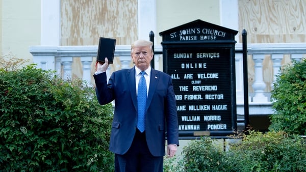 Donald Trump holds a Bible while visiting St John's Church across from the White House after the area was cleared of people protesting the death of George Floyd